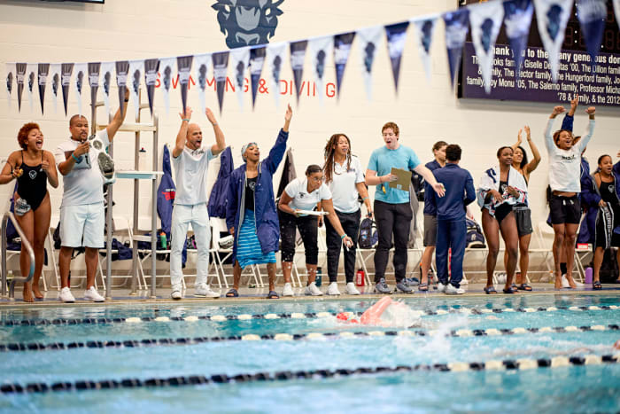 Askew (third from left) urged on his swimmers in an October meet against Mount St. Mary’s. Once chronic losers, the Bison triumphed easily.